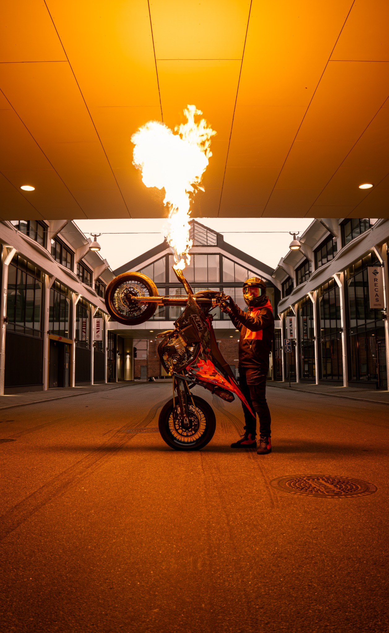 Elliot using the motorcycle's integrated front-fender flamethrower